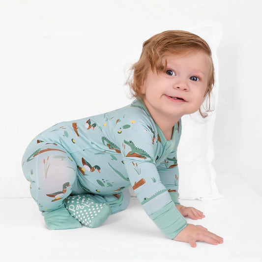 A toddler wears Pearls & Pelicans' bamboo zip-up, Bayou Buddies